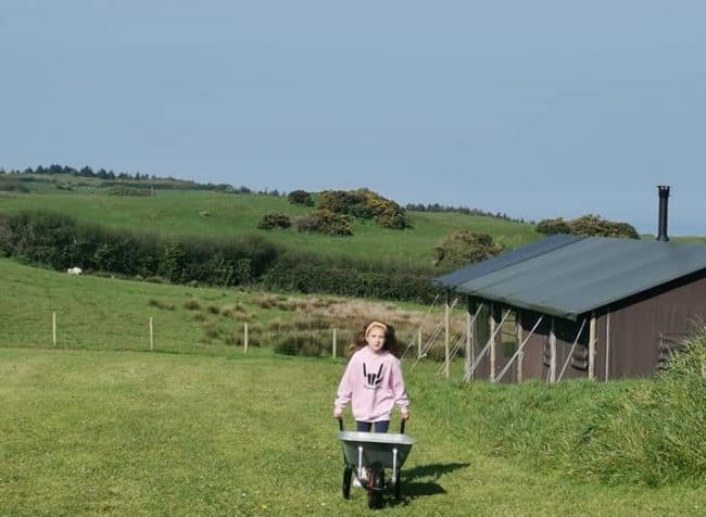 Glamping at Ilfracombe Farm Review 12 emmy with wheelbarrow e1556143091467
