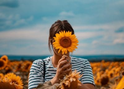 lady holding sunflowers e1555965640835