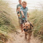 Dog friendly beaches to explore in Cornwall children with dog on the beach