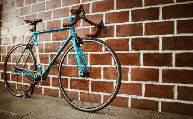 Top Three Destinations in Asia That Should Be on Every Cyclist's Bucket List in 2025 1 bike leaning by brick wall scaled e1721646151830