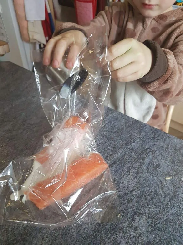 Adding salmon to the oven bags - Cajun Spiced Salmon recipe