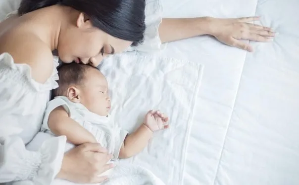 sleeping mother and baby