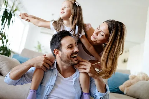 How to Protect Your Family’s Health 1 girl on fathers shoulder cuddling mother