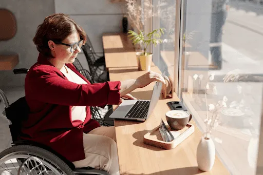 working on laptop from wheelchair