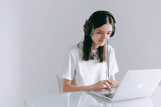 working on laptop with headphones on