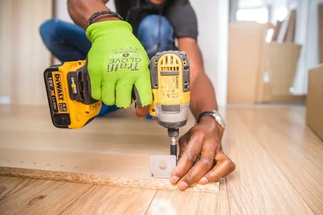 Property Renovations that Will Add the Most Value to your Home in 2025 2 person using cordless impact driver