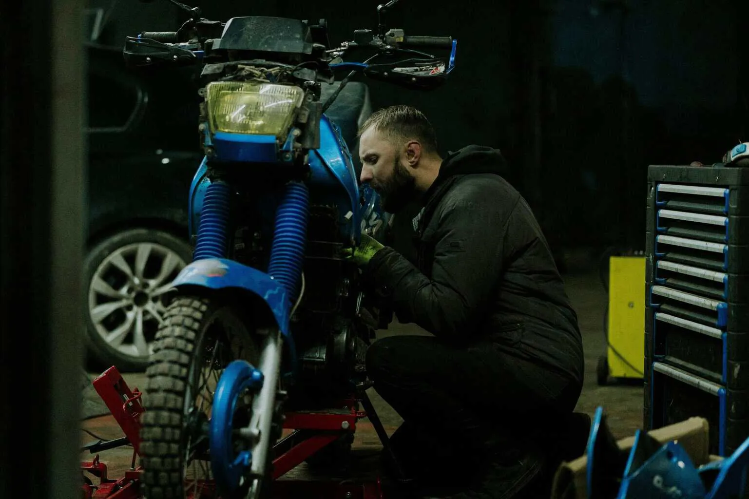 man working on motorcycle scaled